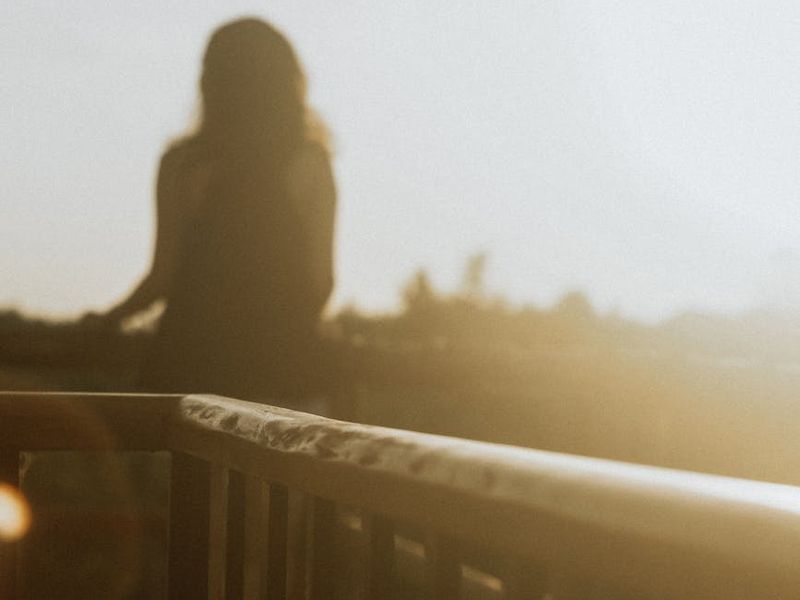 Person looking at the horizon from a balcony in morning